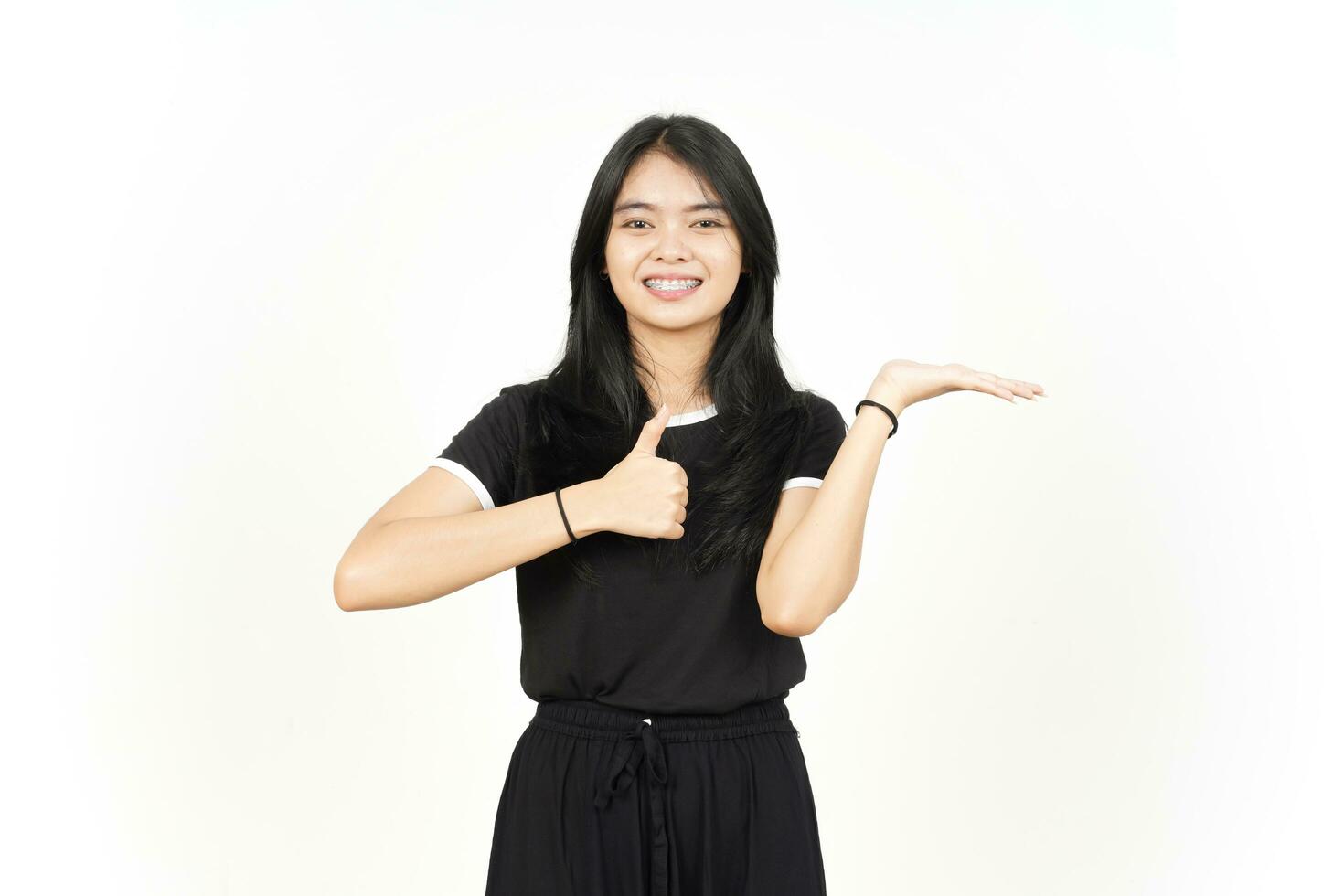 Showing and Presenting Product on Open Palm with Thumbs up Of Beautiful Asian Woman Isolated photo