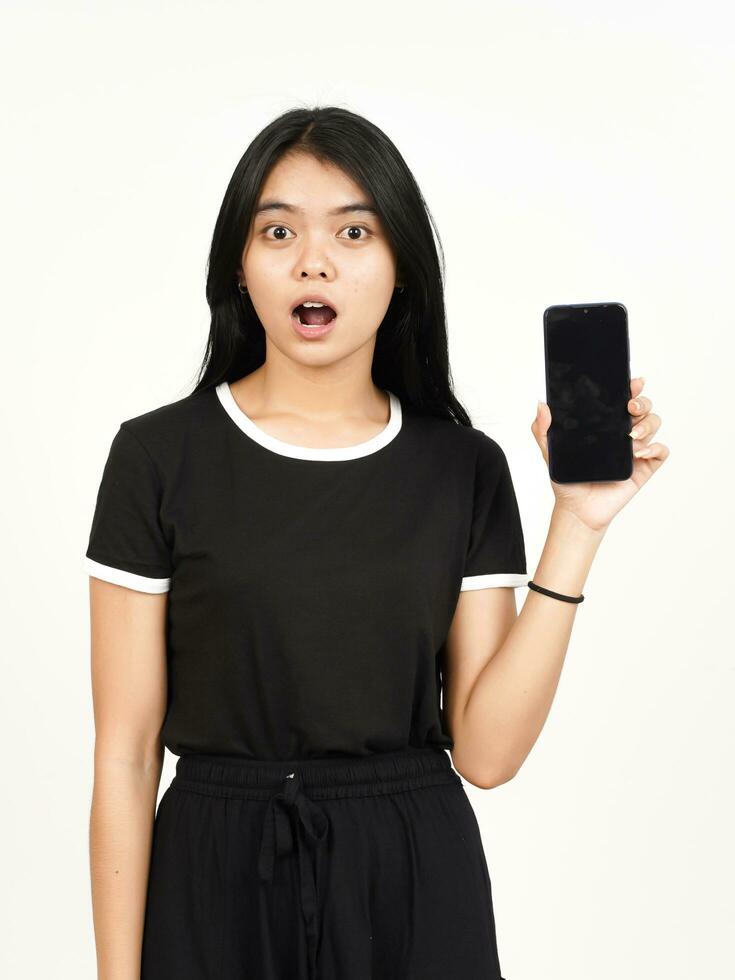 Showing blank smartphone screen with shocked face Of Beautiful Asian Woman Isolated On White photo