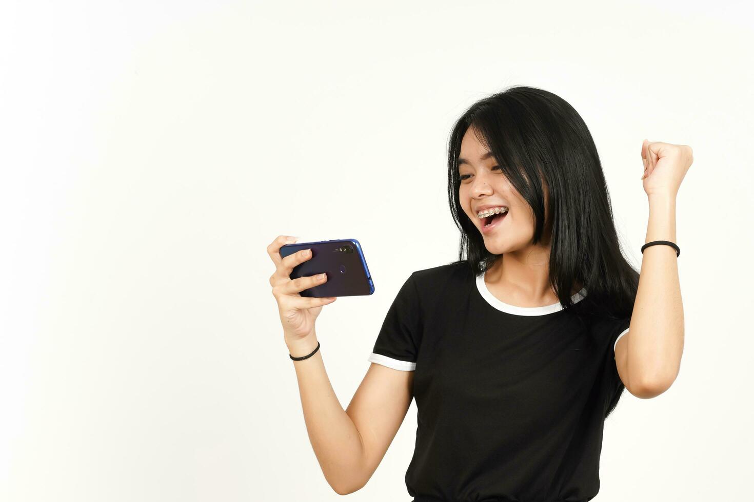 Playing Mobile Game on Smartphone Of Beautiful Asian Woman Isolated On White Background photo