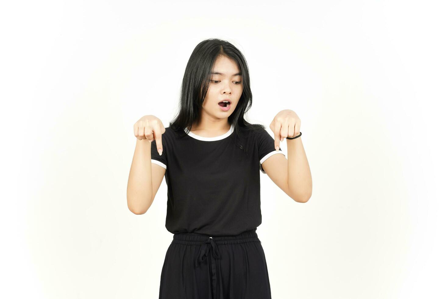 Shocked Face And Pointing Down showing blank copy space Of Beautiful Asian Woman Isolated On White photo