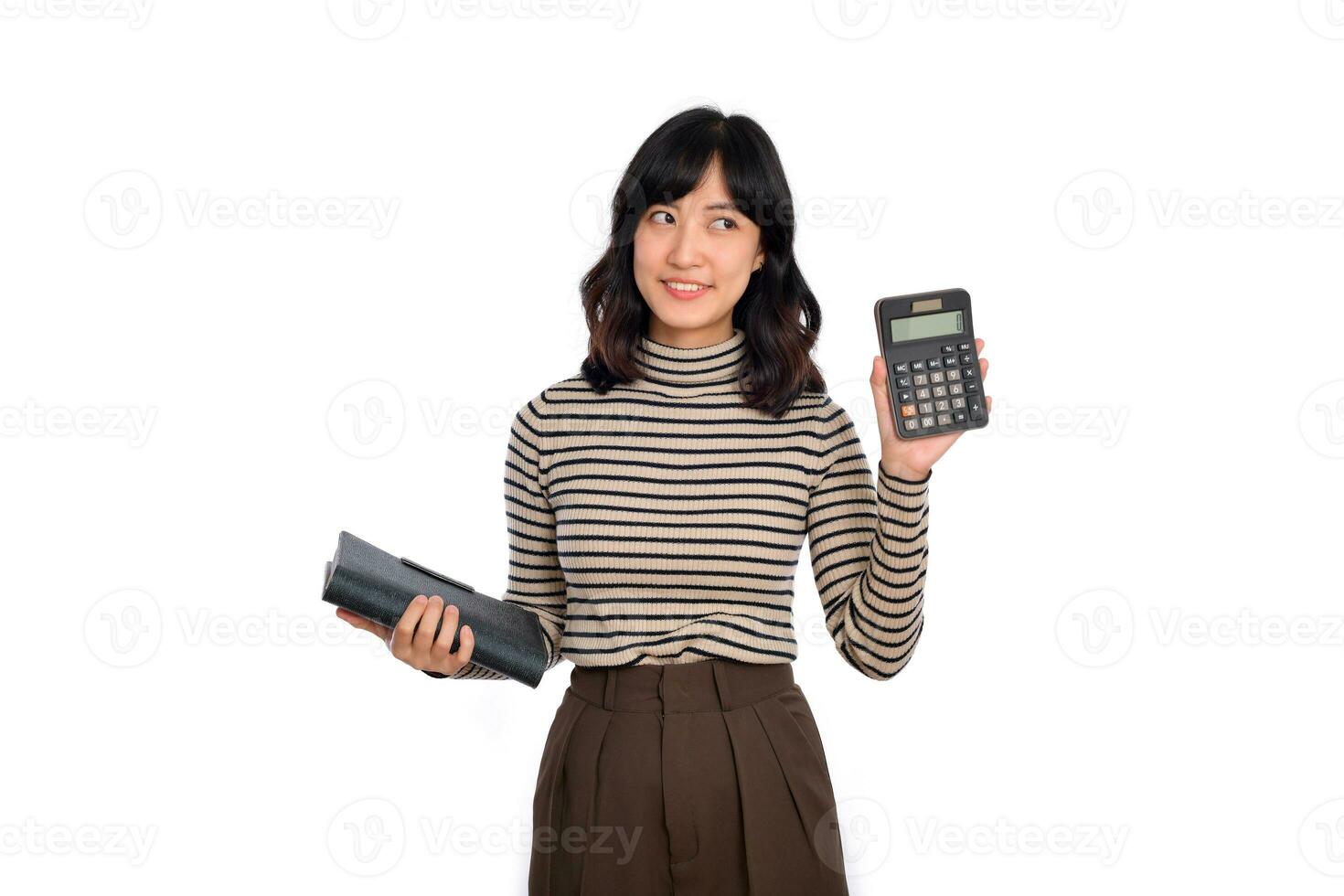 Portrait of young Asian woman casual uniform holding white piggy bank and notebook isolated on white background. Financial and bank saving money concept photo
