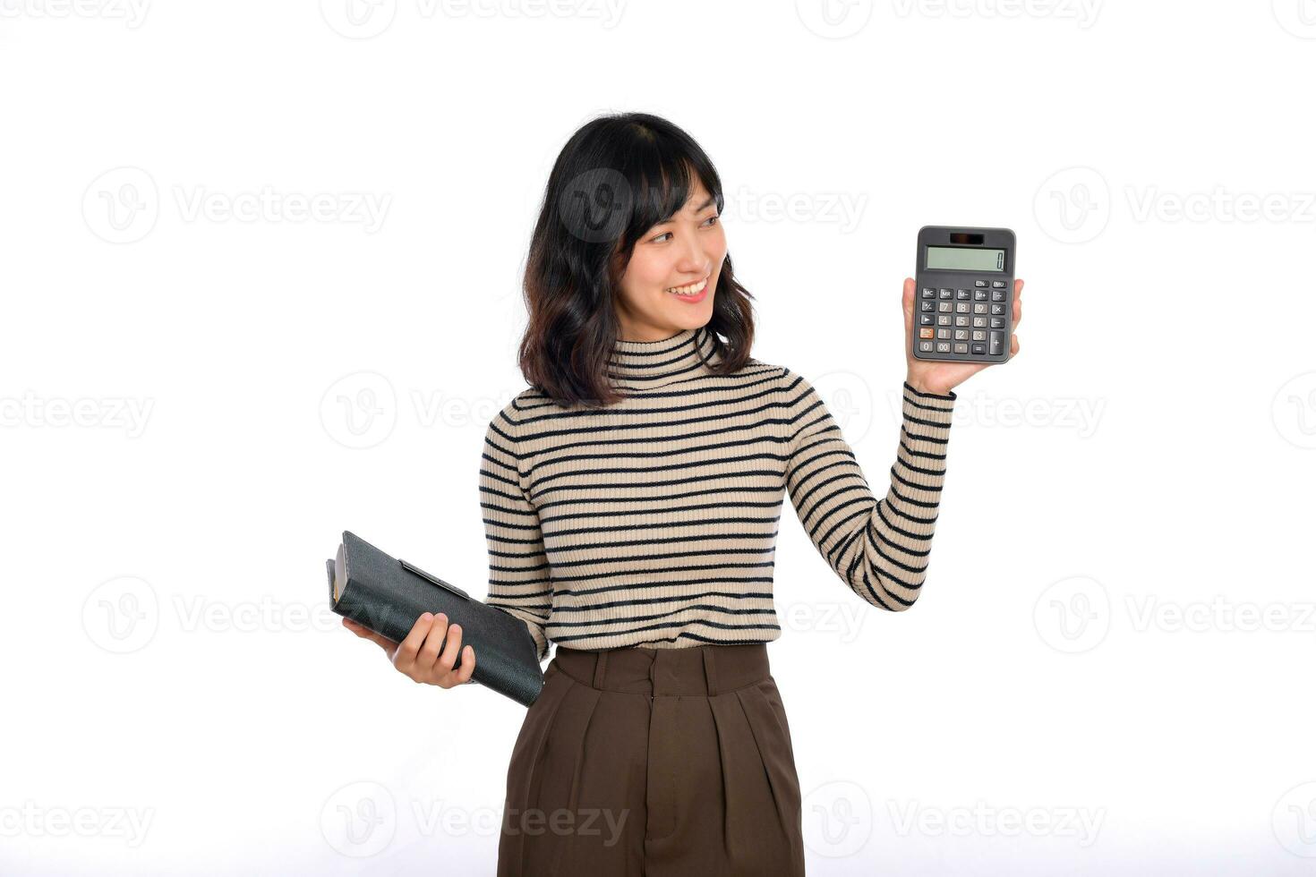 Portrait of young Asian woman casual uniform holding white piggy bank and notebook isolated on white background. Financial and bank saving money concept photo