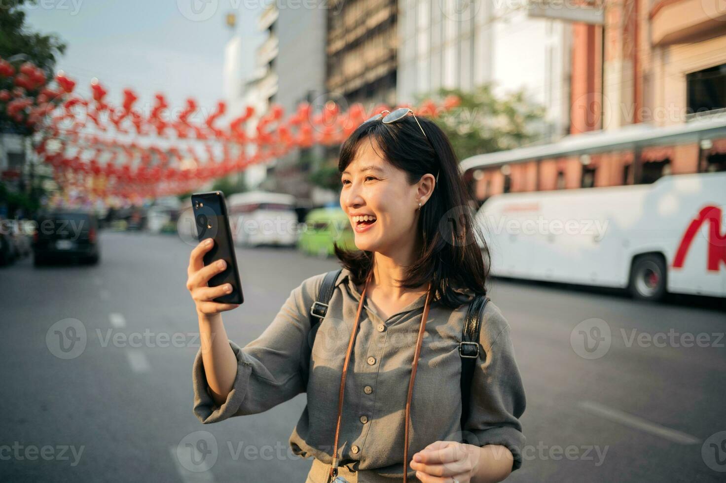 Young Asian woman backpack traveler enjoying China town street food market in Bangkok, Thailand. Traveler checking out side streets. photo