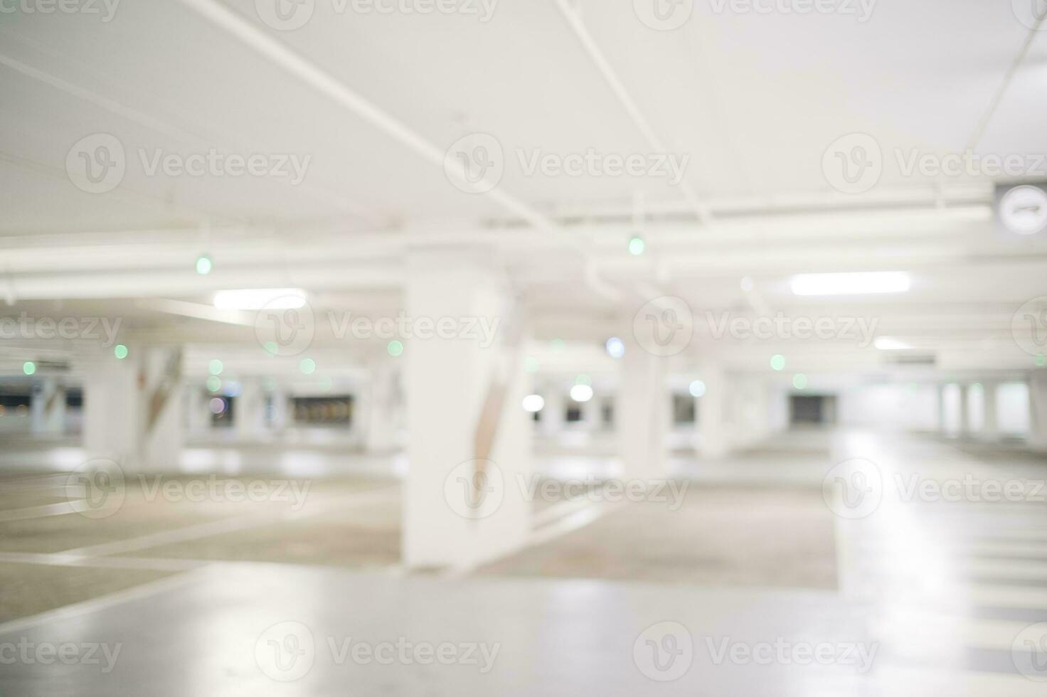 Blur image of empty car park in basement of garage shopping mall. Defocused interior background concept photo