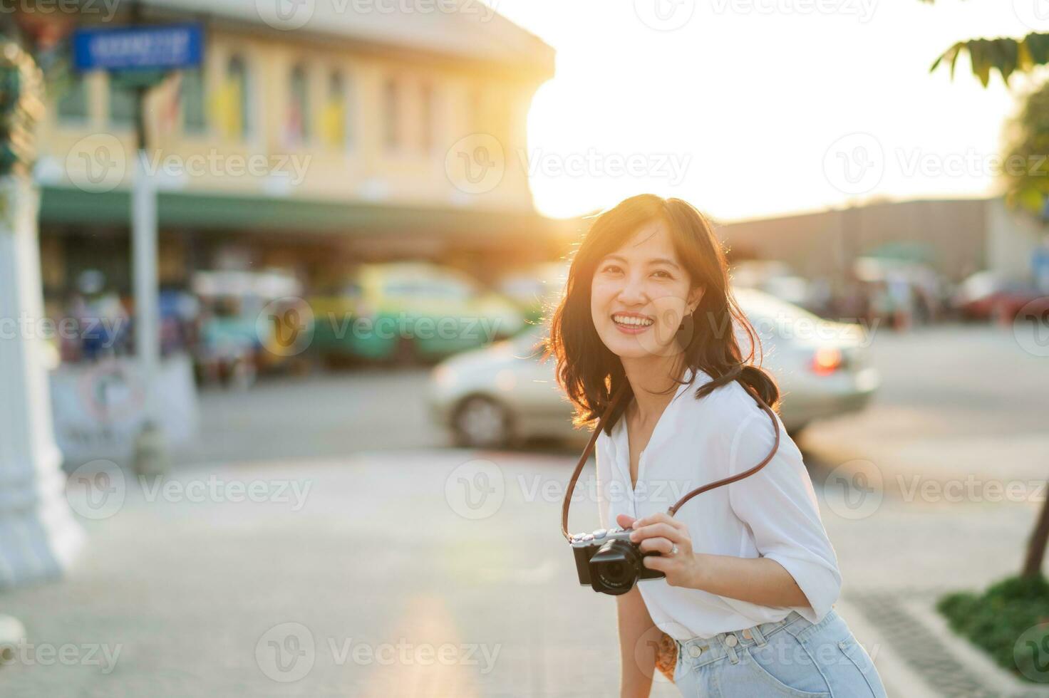 Portrait of asian woman traveler using camera at street of Bangkok, Thailand. Asia summer tourism vacation concept photo