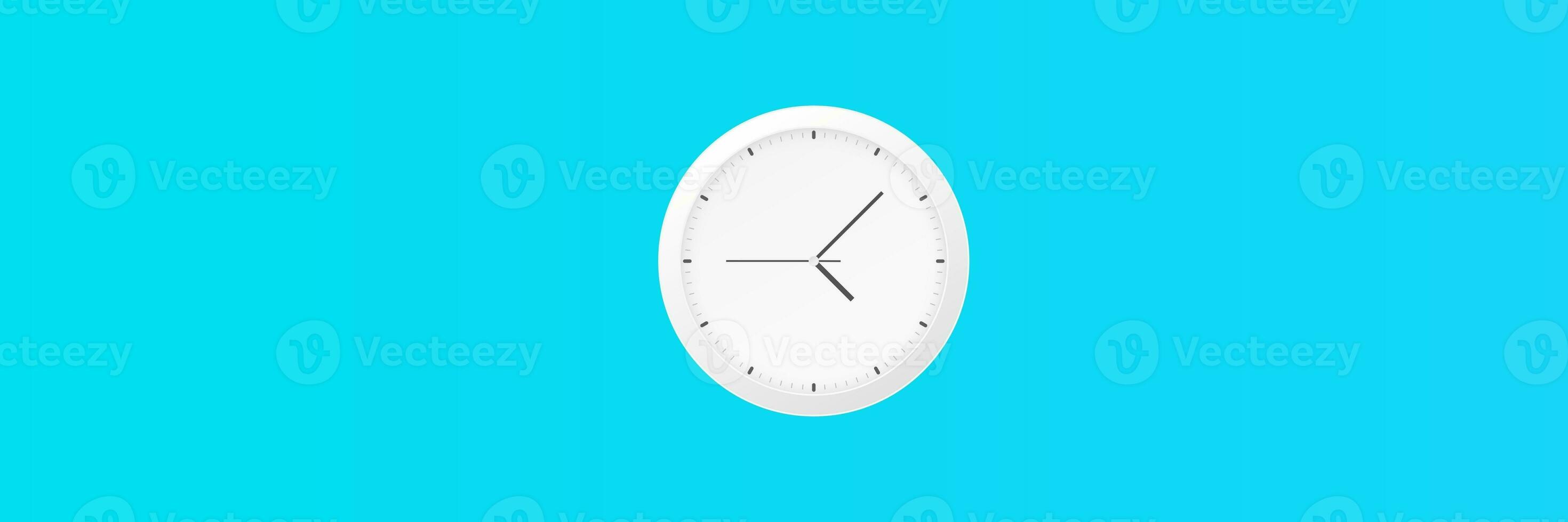 White wall clock with black second hand hanging on the wall. Minimalist flat lay image of plastic wall clock over blue turquiose background with copy space and central composition. photo