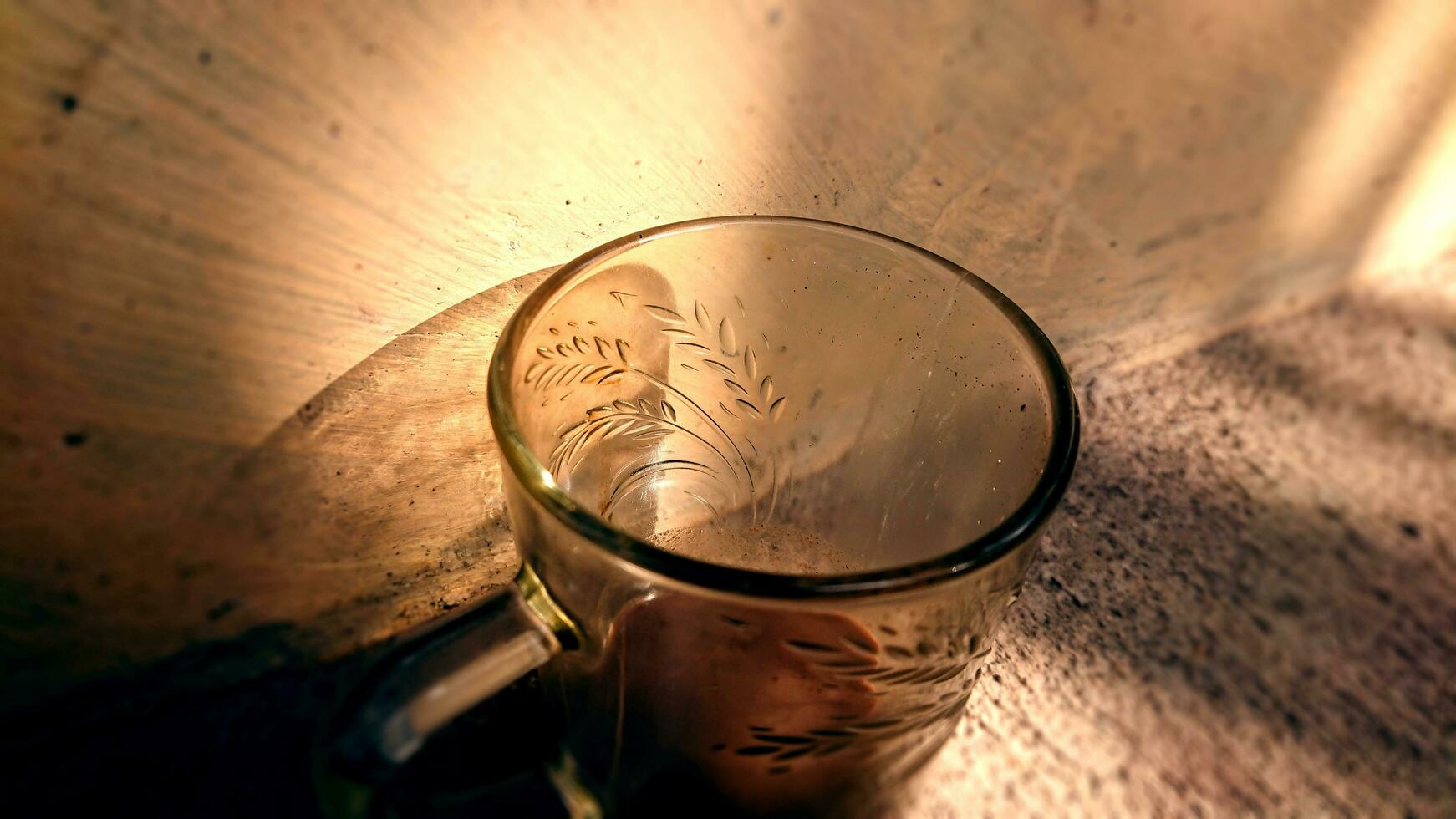 an empty glass exposed to the morning sun photo