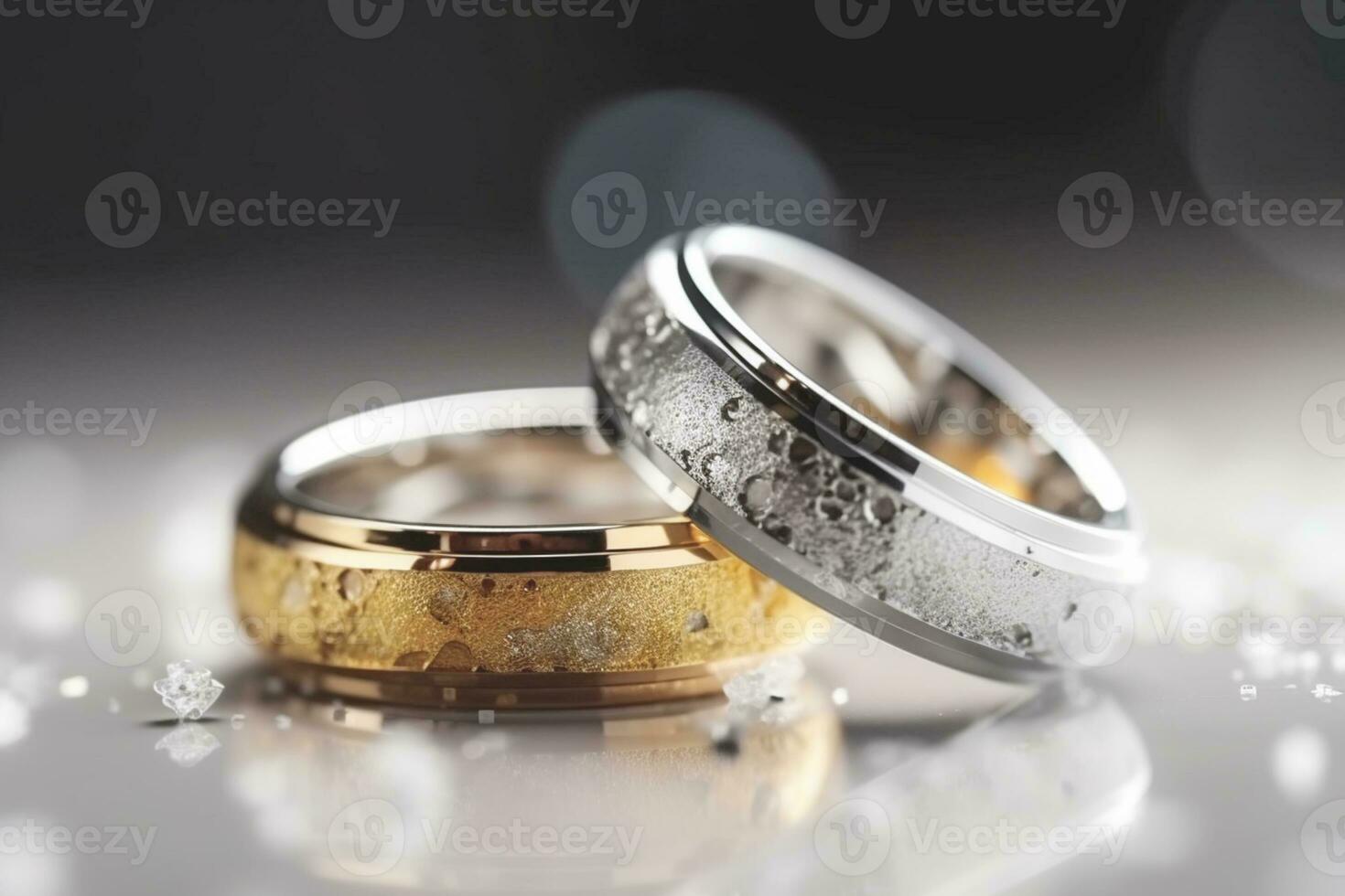 Wedding rings with silver and gold on bokeh background in the style of glitter and diamond dust. Closeup photo with copy space for text