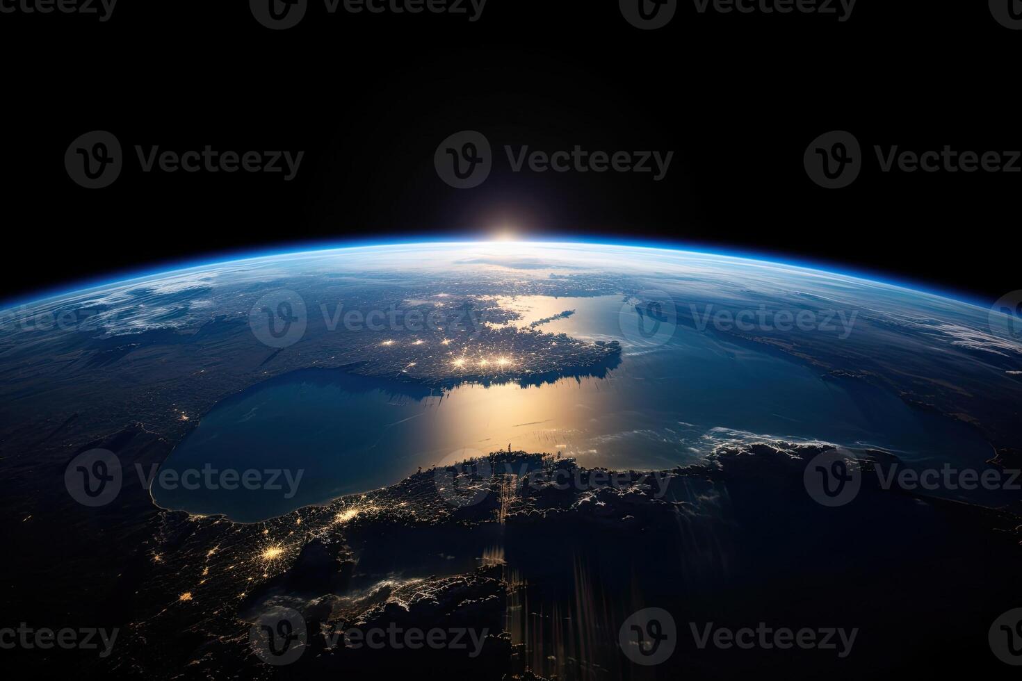 Sunrise view of the planet Earth from space with the sun setting over the horizon. photo