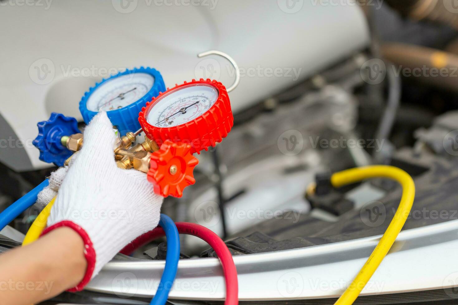 Repairman holding monitor tool to check and fixed car air conditioner system, Technician man check car air conditioning system refrigerant recharge, Air Conditioning Repair photo