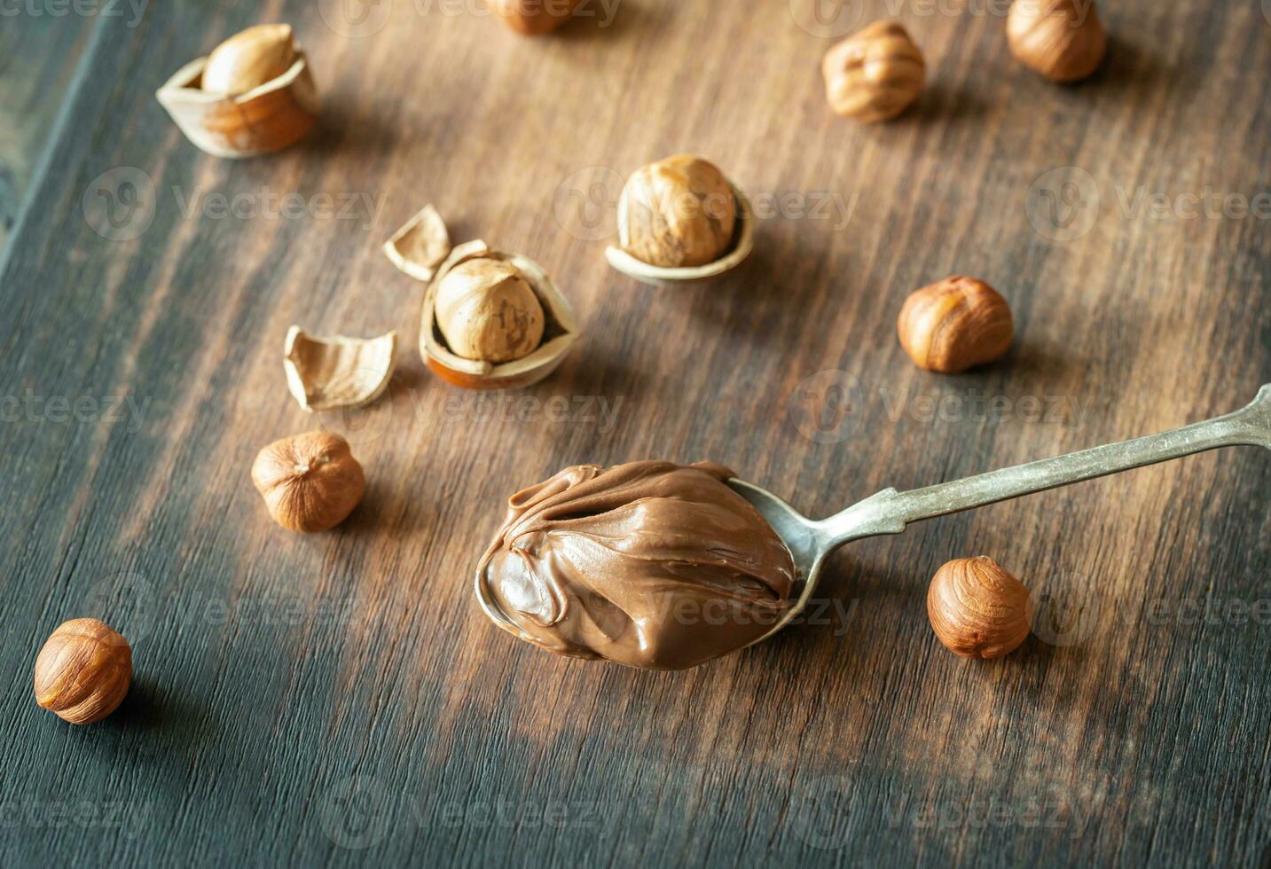 Spoon of chocolate paste with hazelnuts photo