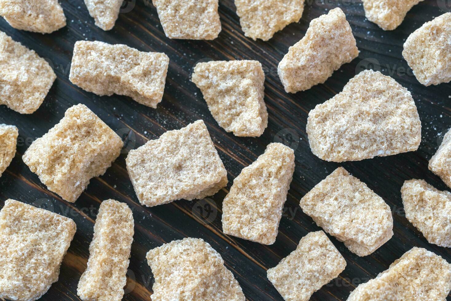 Brown sugar on the wooden background photo