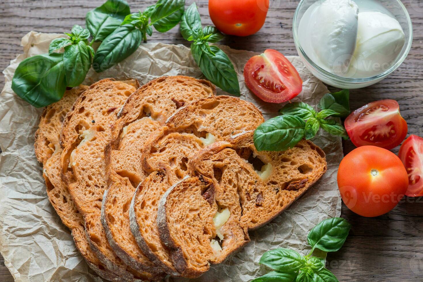 Slices of tomato bread with mozzarella photo