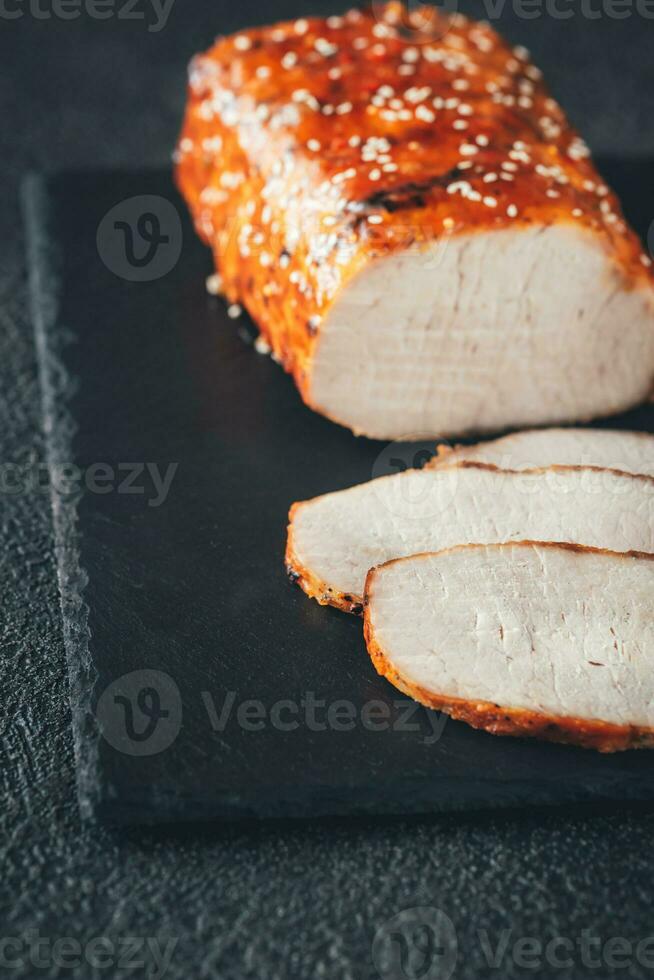 Baked meat on the black sone board photo