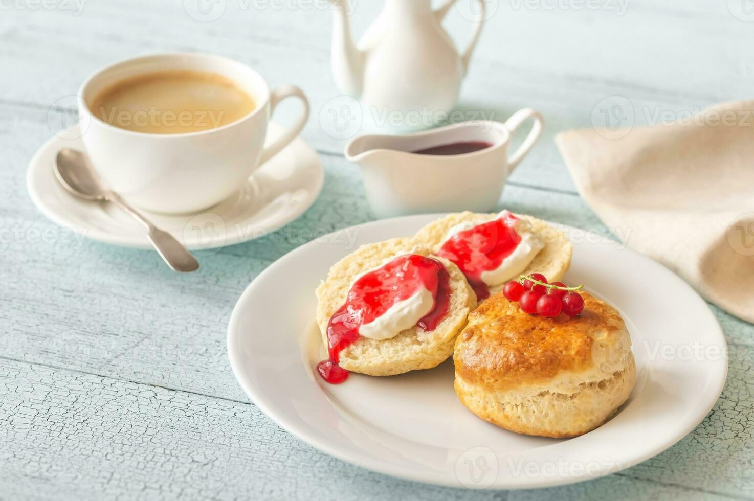Classic scones with cream and berry jam photo