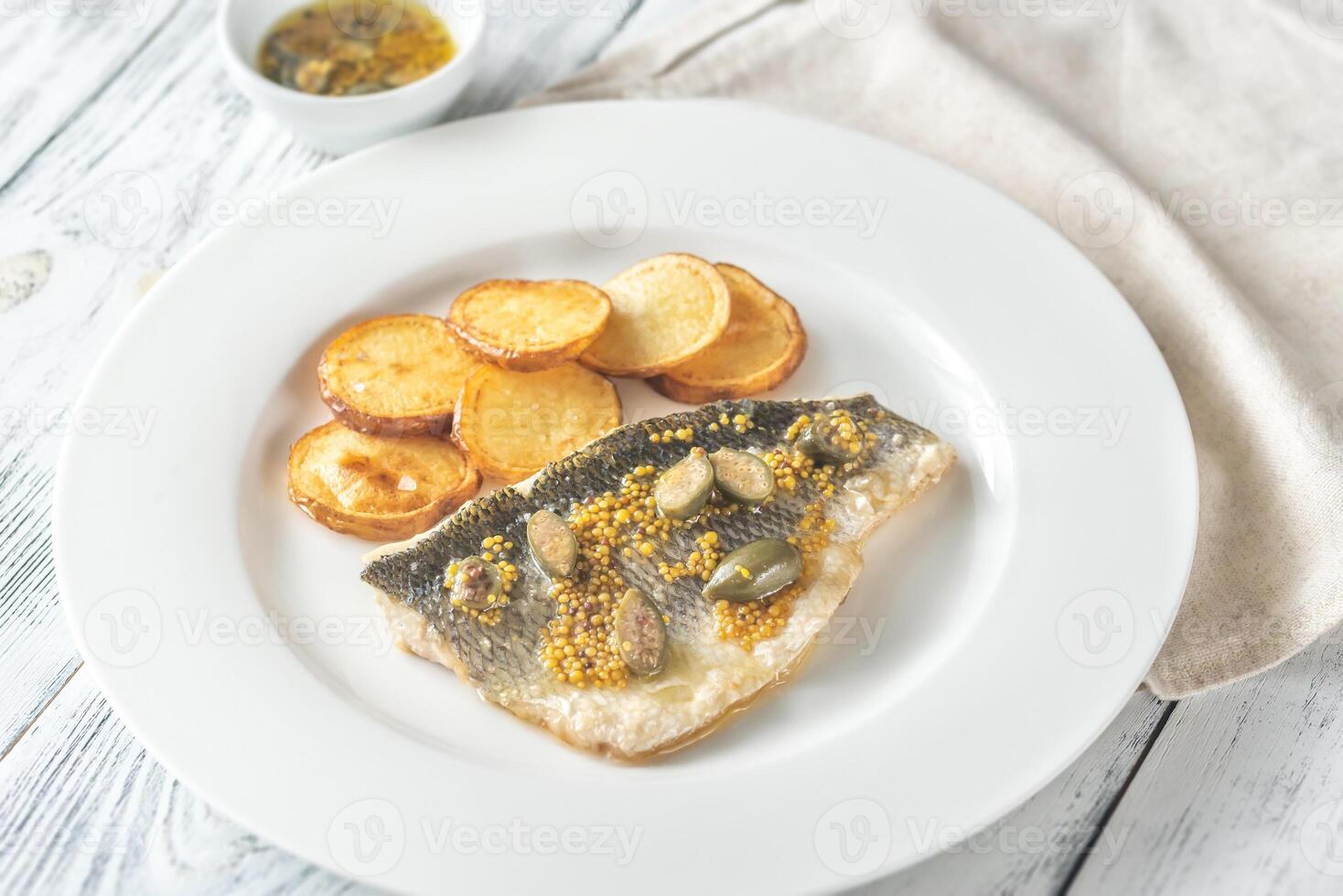 Baked sea bass with capers 23491357 Stock Photo at Vecteezy
