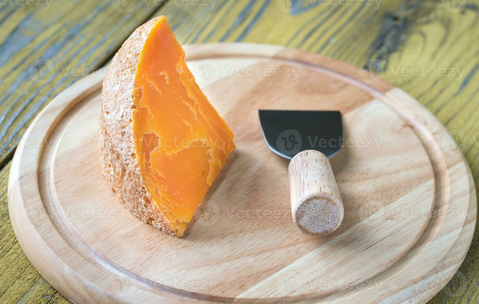 Mimolette cheese on the wooden board photo