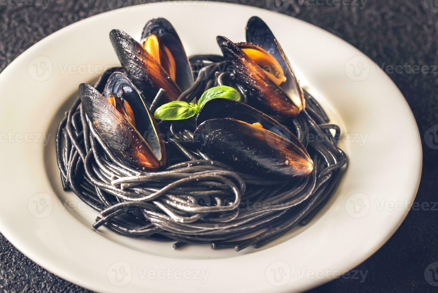 Black pasta with mussels photo