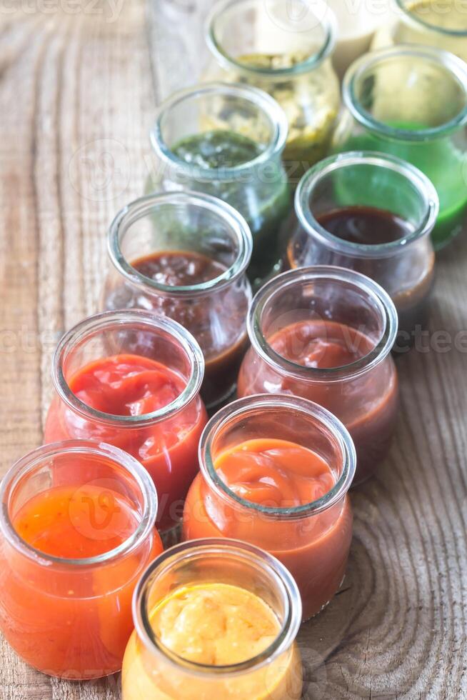 Assortment of sauces in the glass jars 23491746 Stock Photo at Vecteezy