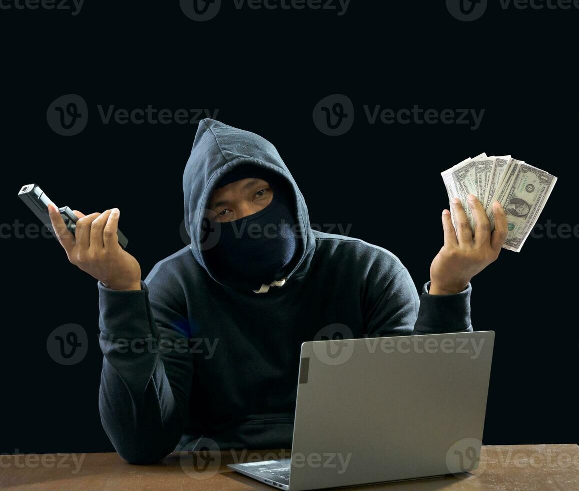 Hacker spy man one person in black hoodie sitting on a table looking computer laptop used login password attack security to circulate data digital in internet network system, night dark background. photo