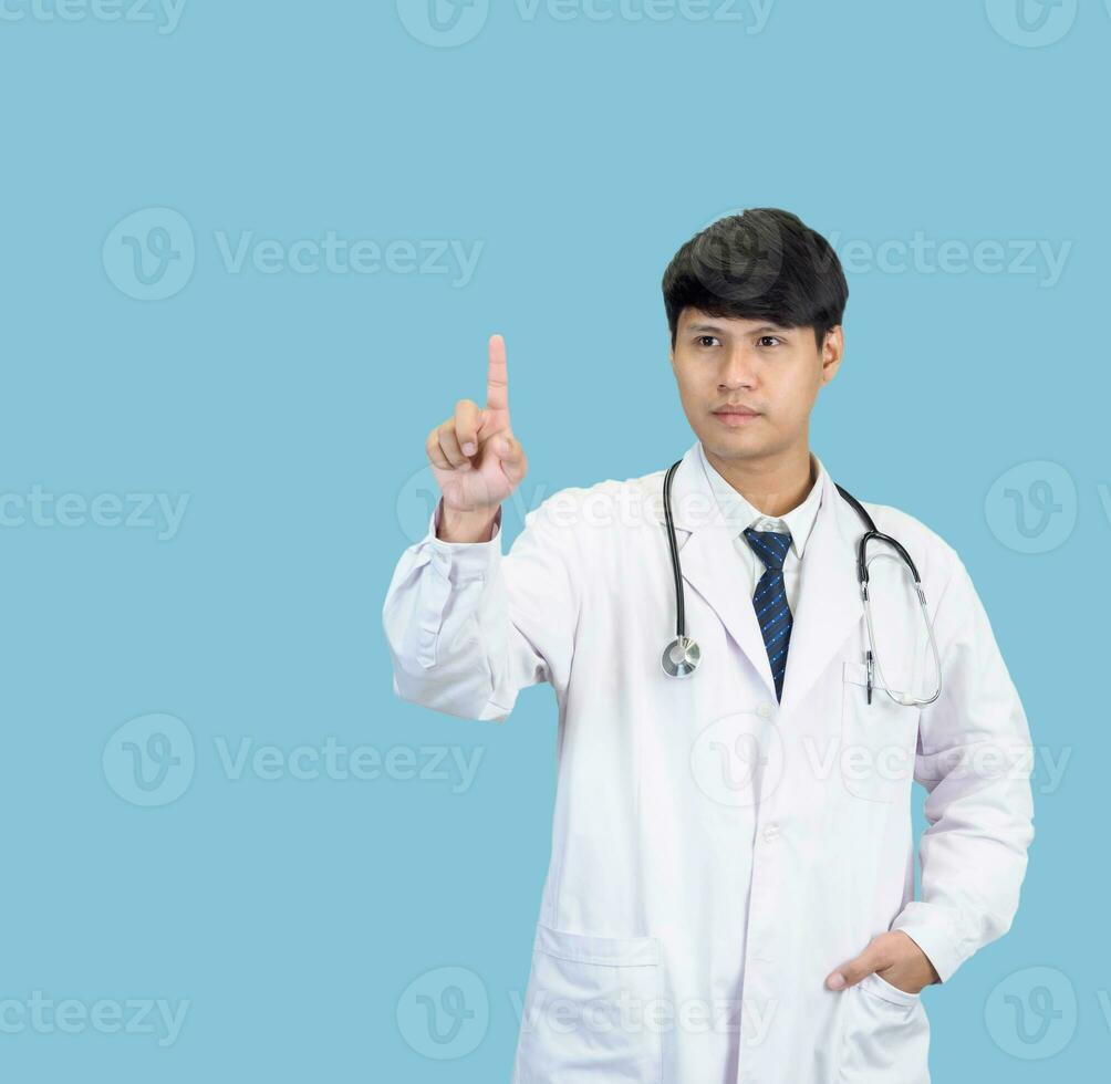 Asian man student scientist or doctor one person, wearing a white gown, standing, looking and smiling, blue background with a stethoscope auscultating the heart around his neck. photo