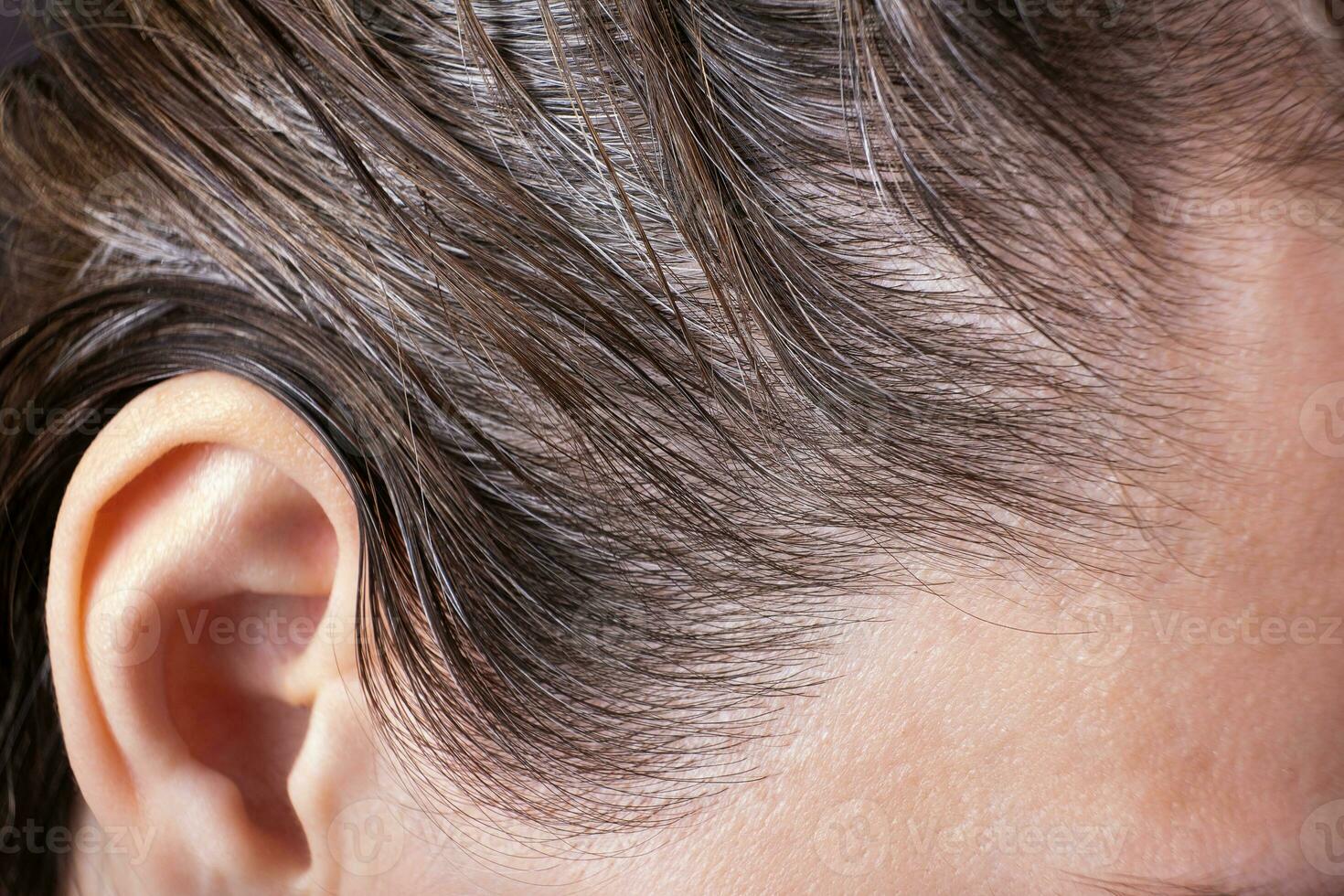 Close up fragment of female head with gray hair photo