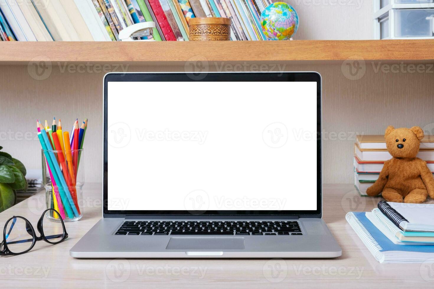 Laptop on desktop with blank screen in children's room. Kid education mockup, template photo