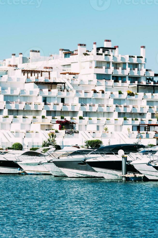 View of luxurious yachts next to an unidentifiable villa photo
