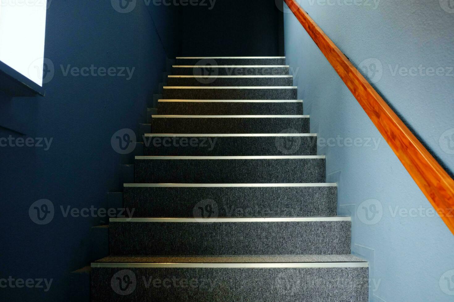 Close up Stair Steps with Light Beam from Window on Wall Surface. photo