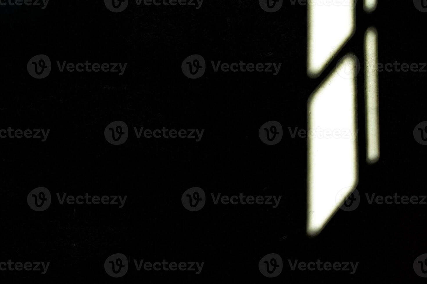 Light Beam from Window on Wall in Dark Room Interior Background with Space for Text. photo