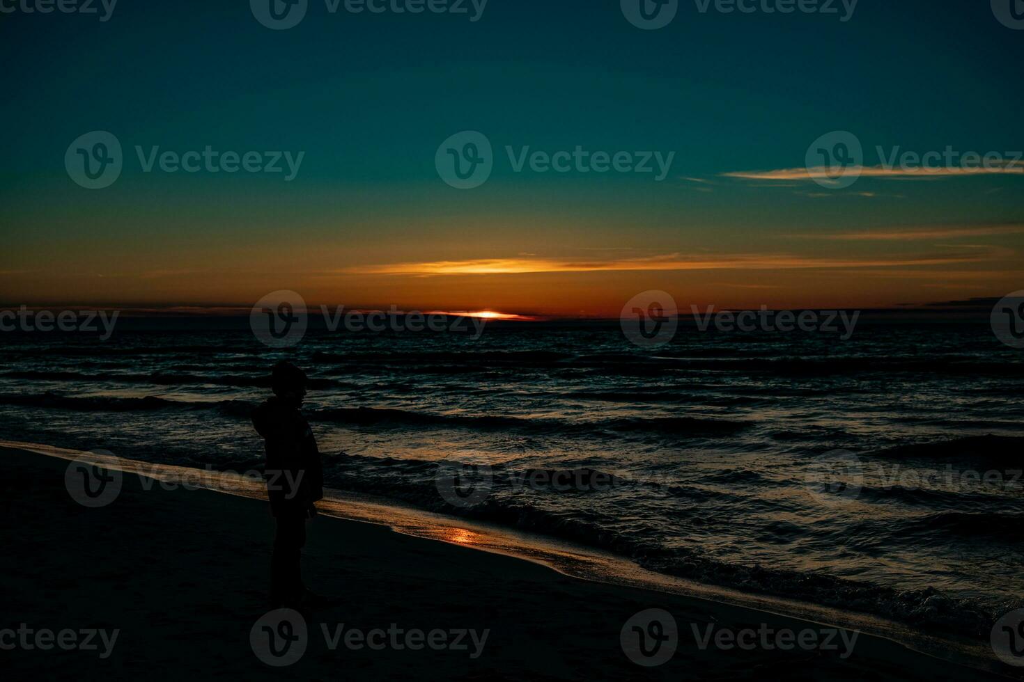 picturesque calm sunset with colorful clouds on the shores of the Baltic Sea in Poland photo