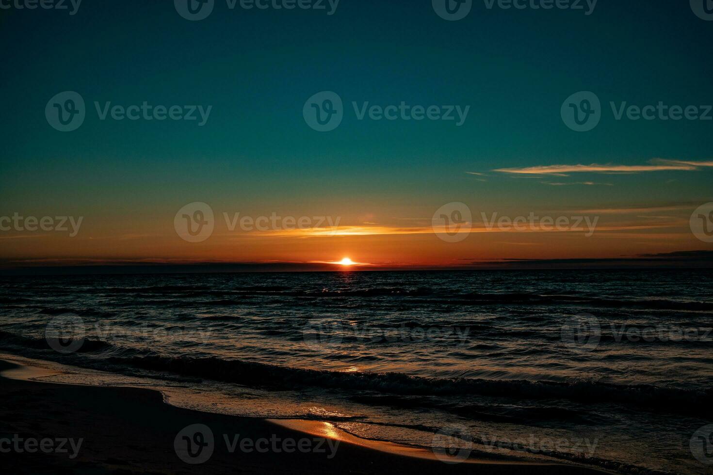 picturesque calm sunset with colorful clouds on the shores of the Baltic Sea in Poland photo