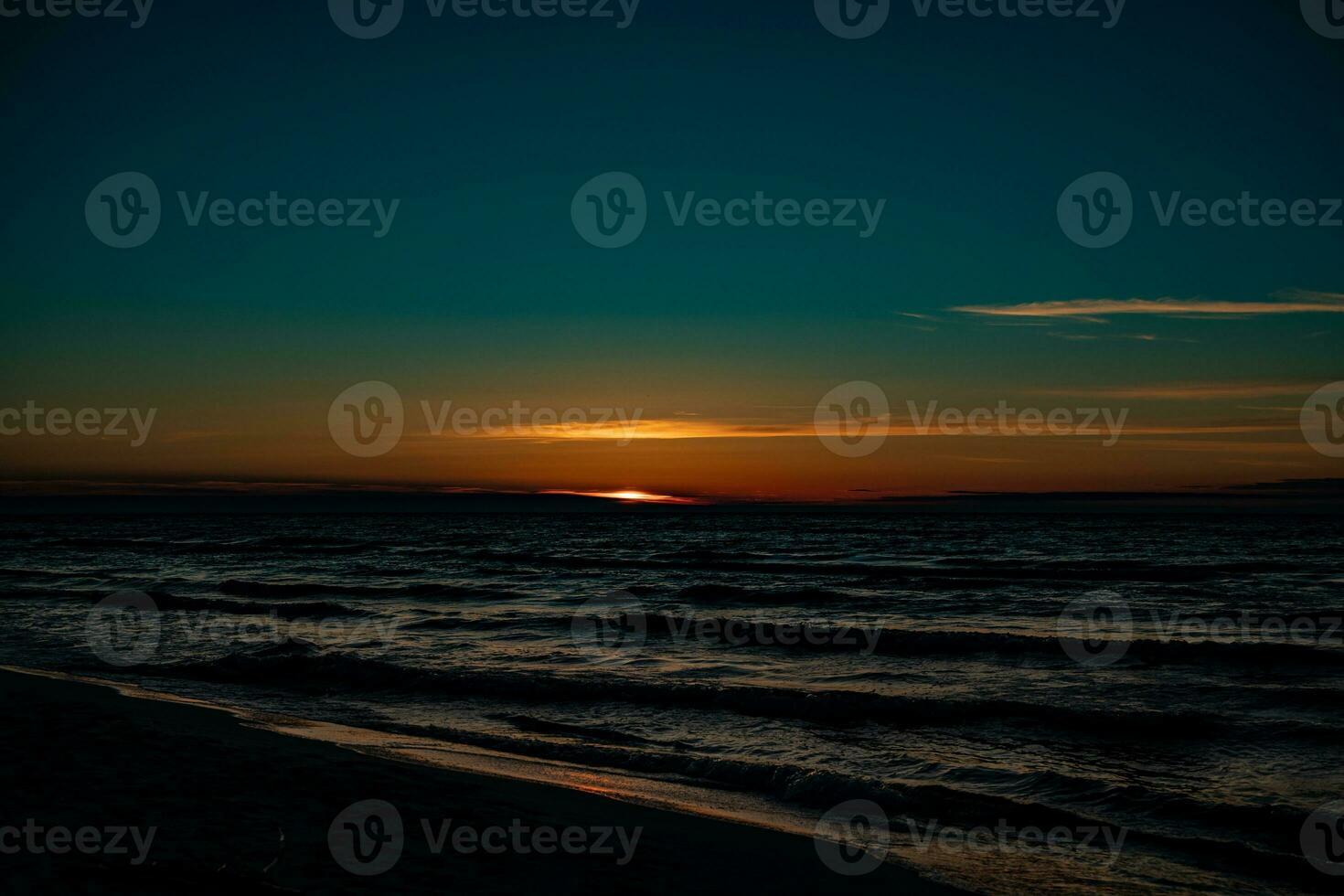 picturesque calm sunset with colorful clouds on the shores of the Baltic Sea in Poland photo