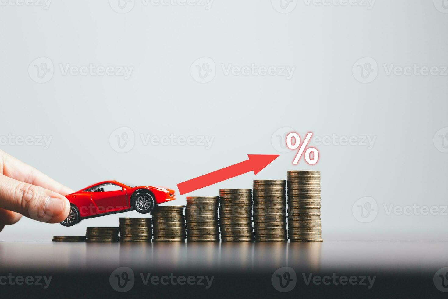 Stacks of coins and red car with percentage symbol for increasing interest rates. Interest rate financial and mortgage rates. Icon percentage symbol and arrow pointing up. photo