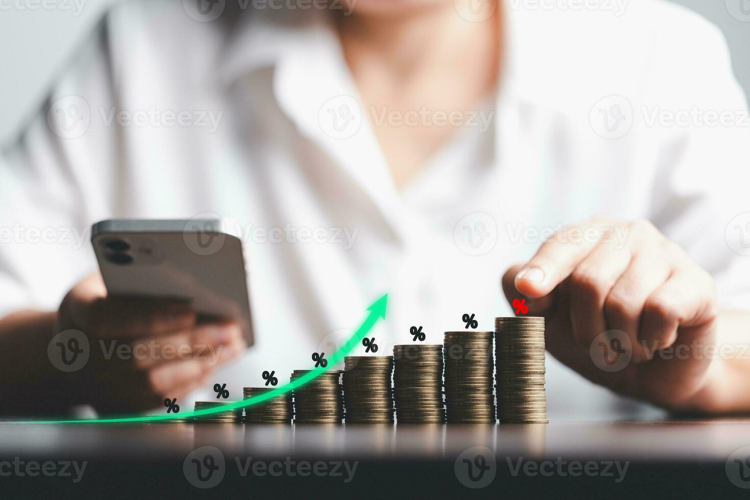 Business woman hand and stack coins money with up arrow and percentage symbol of Interest rate financial and mortgage rates. Icon percentage symbol and arrow pointing up. photo