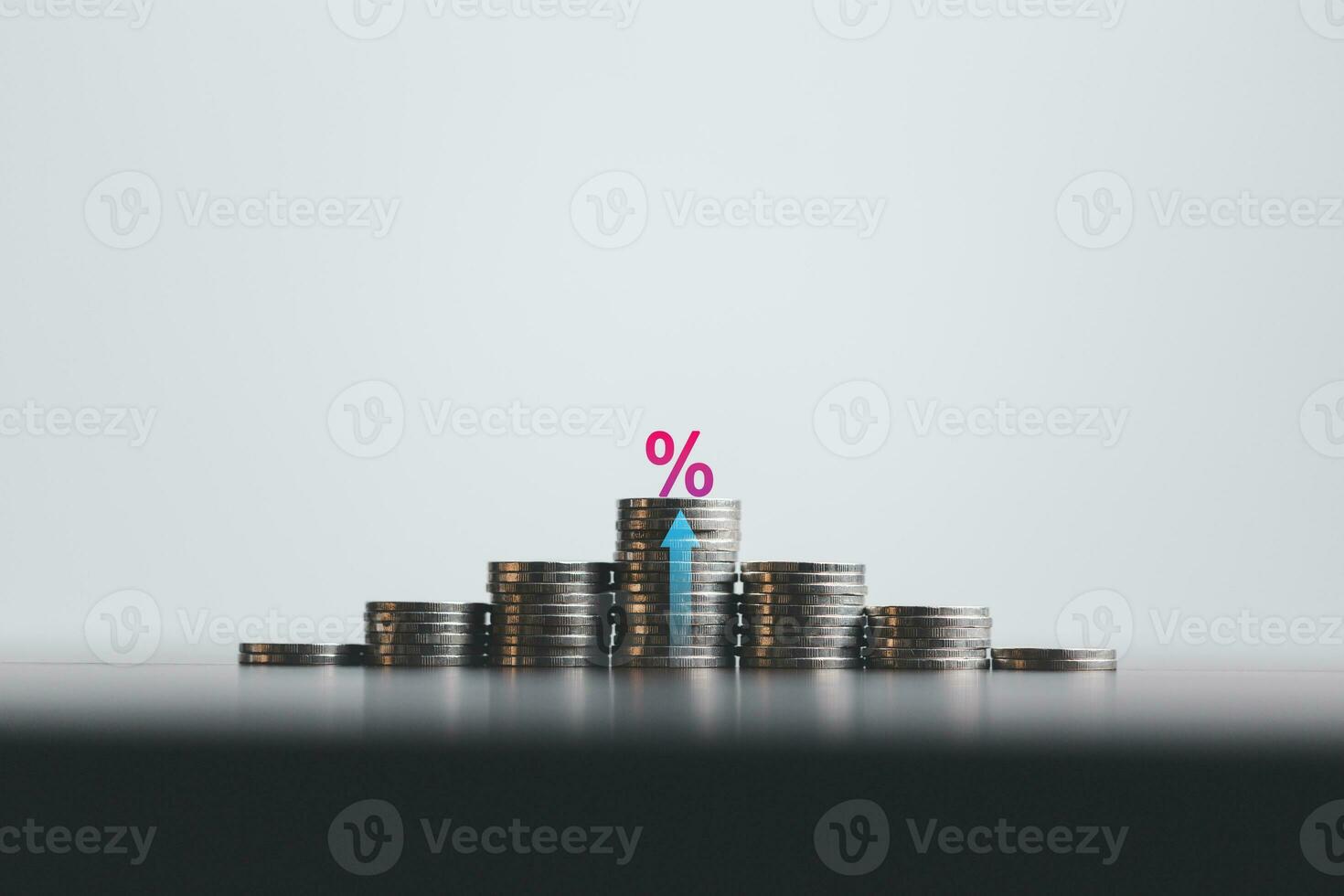 Stacked coins on wooden table with illustration shows increasing of interest rates, financial concept. Interest rate financial and mortgage rates. Icon percentage symbol and arrow pointing up. photo