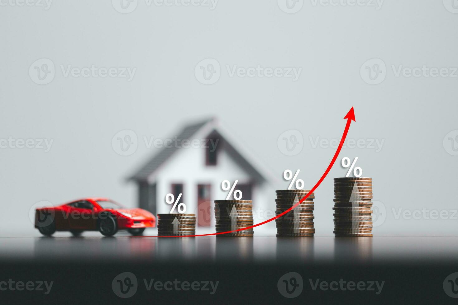 Stacks of coins and model house and car with percentage symbol for increasing interest rates. Interest rate financial and mortgage rates. Icon percentage symbol and arrow pointing up. photo