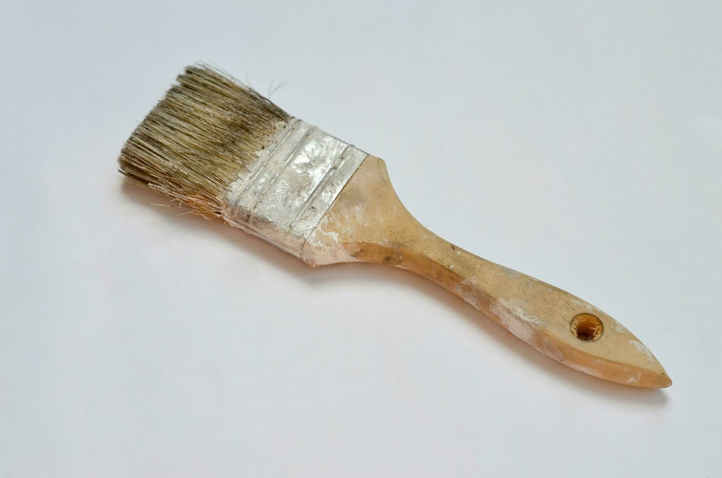 used paint brush isolated at white background photo