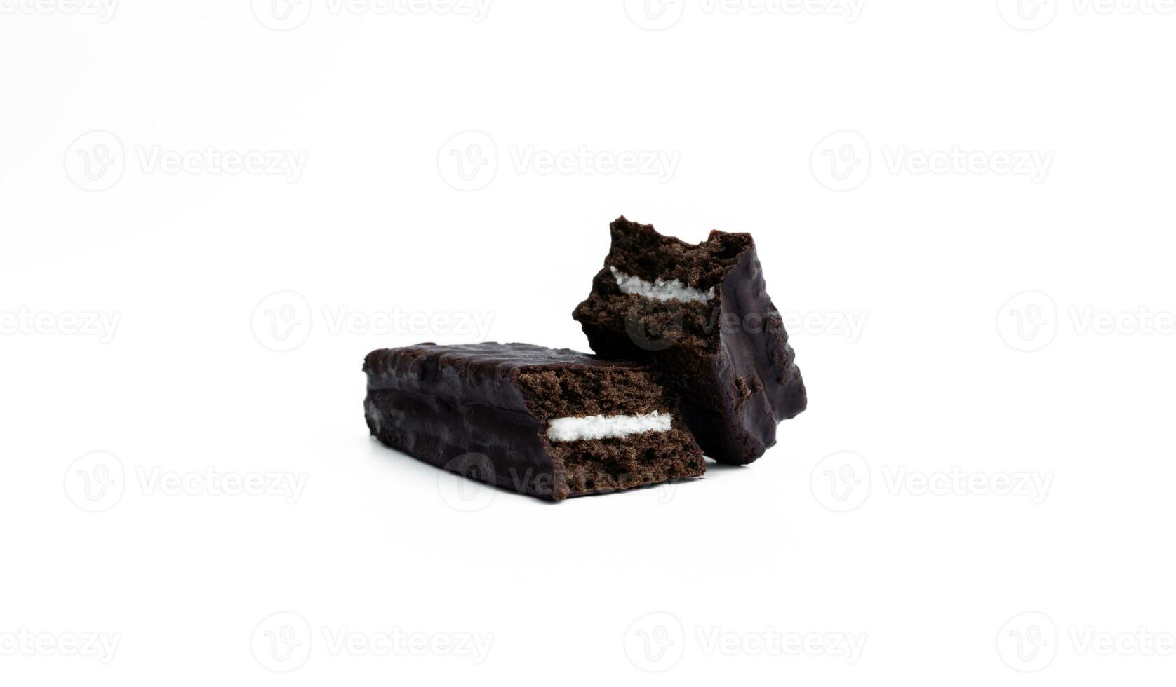 A chocolate soft cake filled with vanilla cream isolated on white background, after some edits. photo