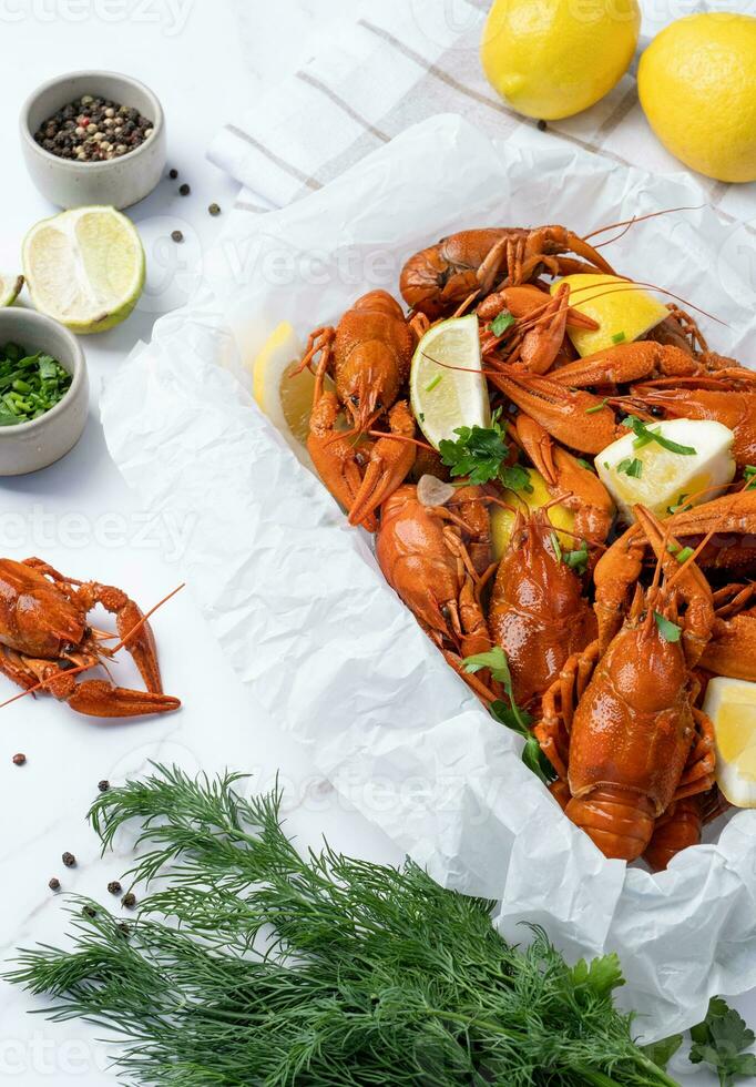 top view of cooked crawfish platter with lemons and spices photo