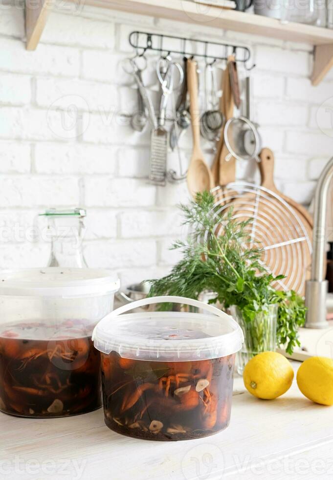 Homemade Crawfish in plastic buckets on kitchen counter, food delivery photo