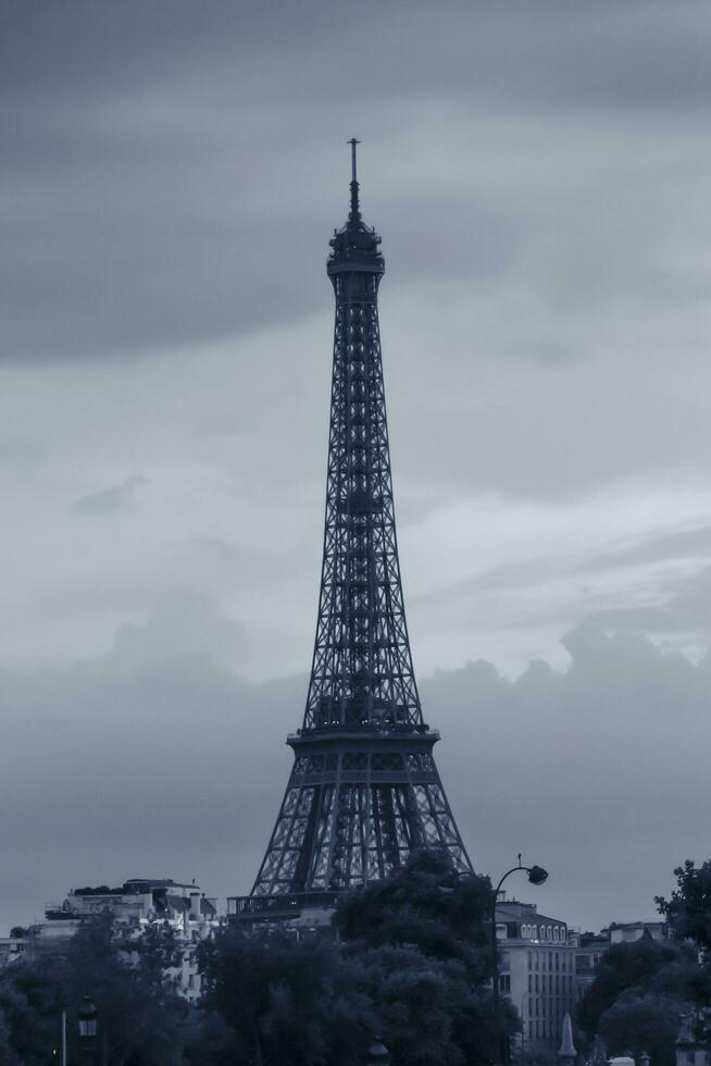 Eiffel Tower in Paris against clouds at evening photo