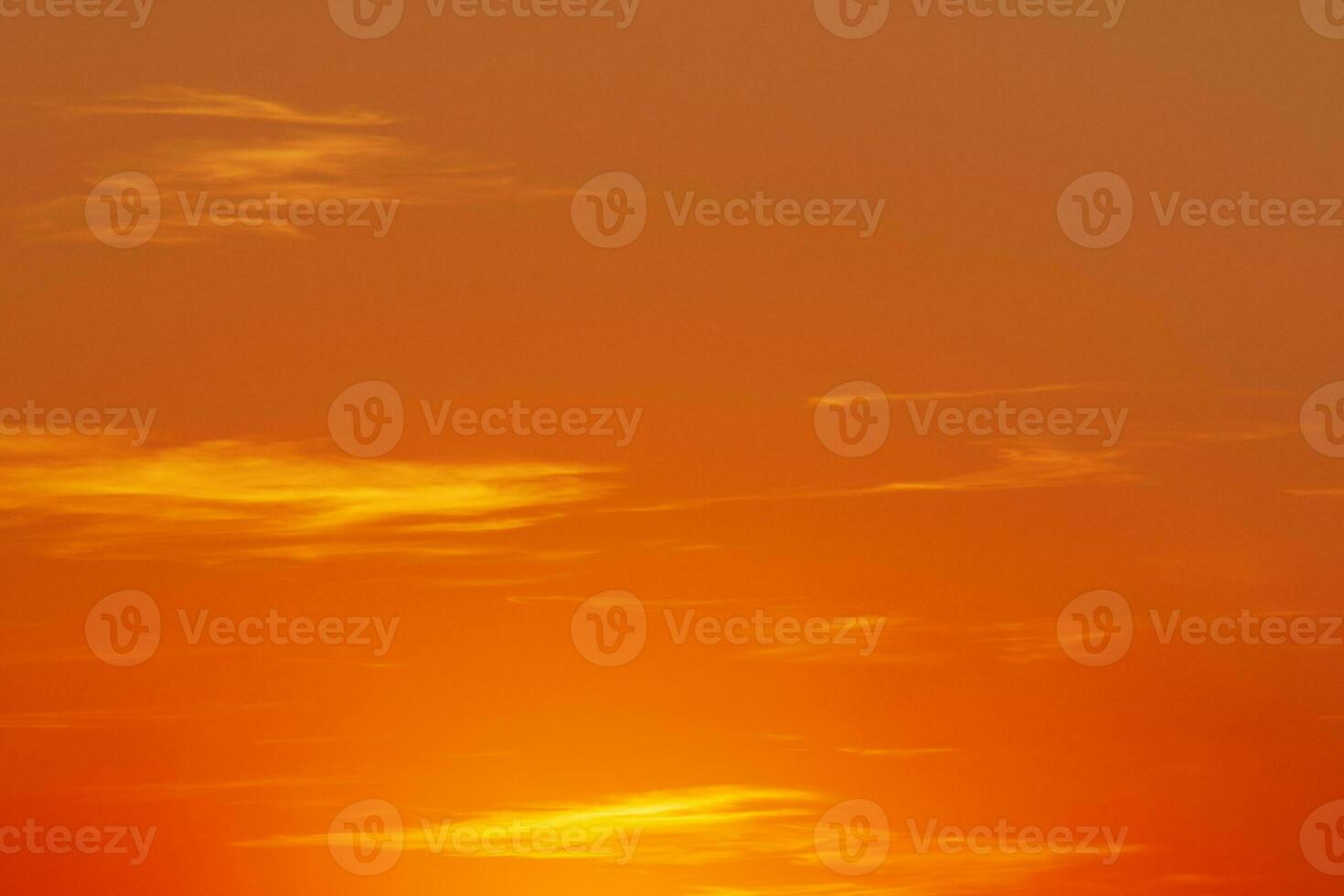 view on bright orange sky with yellow clouds at sunset photo