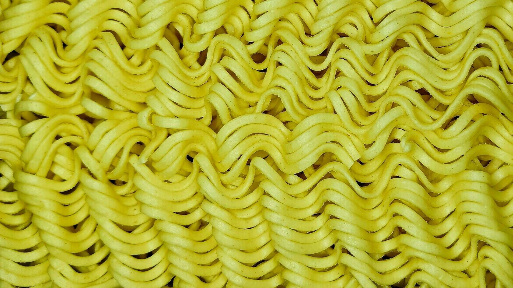 Noodles texture, The photo showcases a close-up of delicious, noodles with a beautifully textured surface. Perfect for food-related publications and packaging.