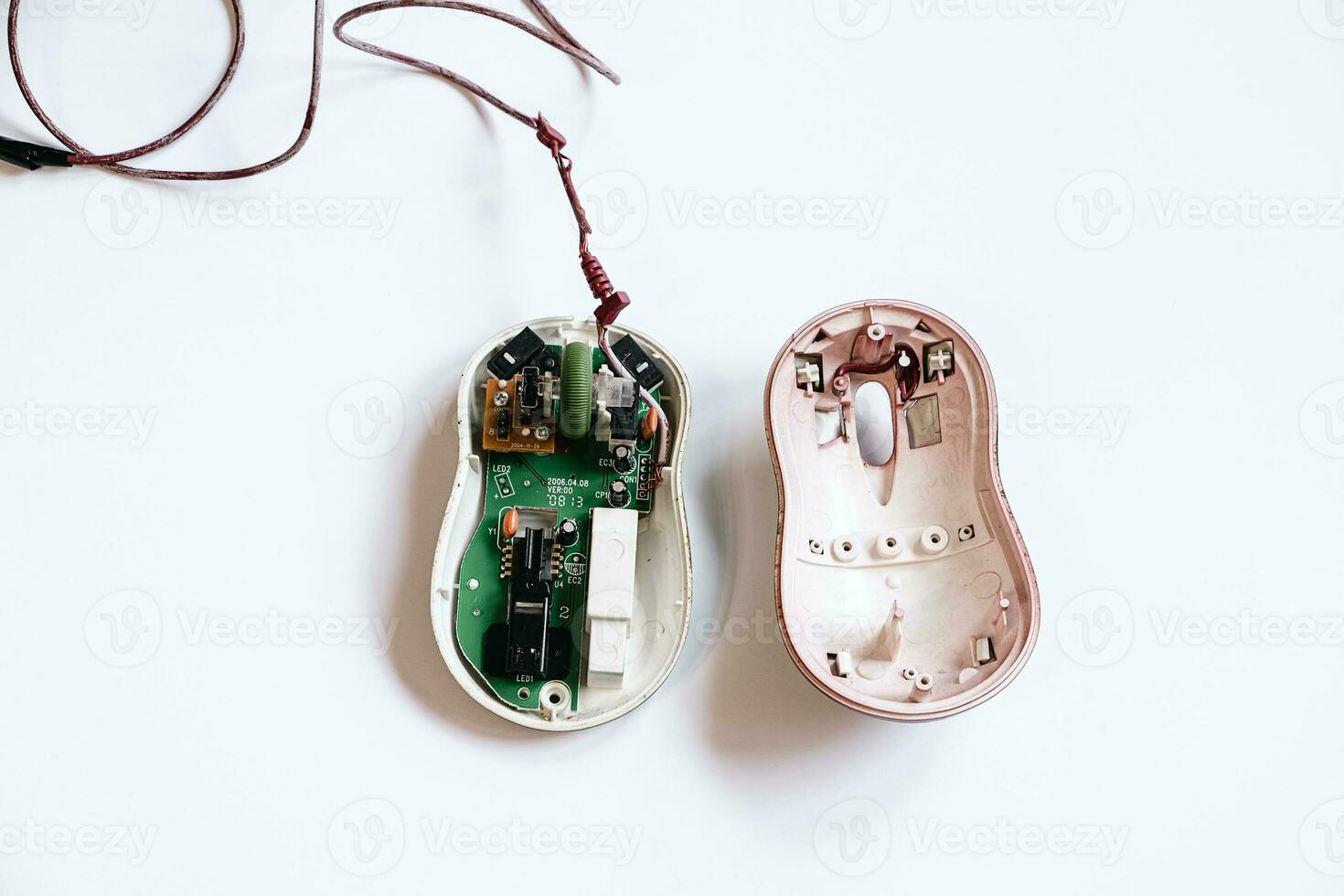 Disassembled computer mouse on white background. Gadget repair. photo