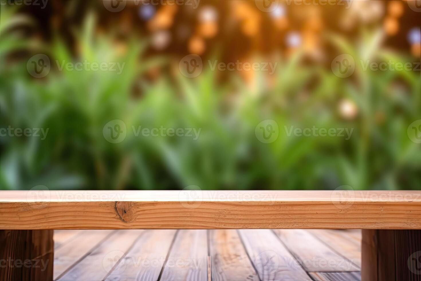 Image of wooden table in front of abstract blurred background made of plants. photo