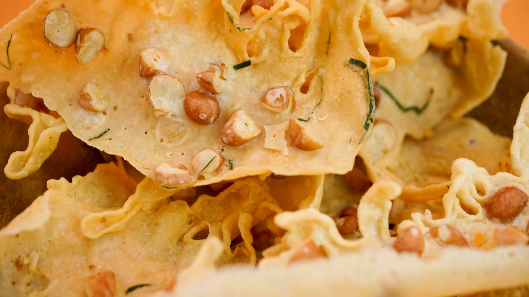 Close-up of peyek with salted peanuts and dill photo