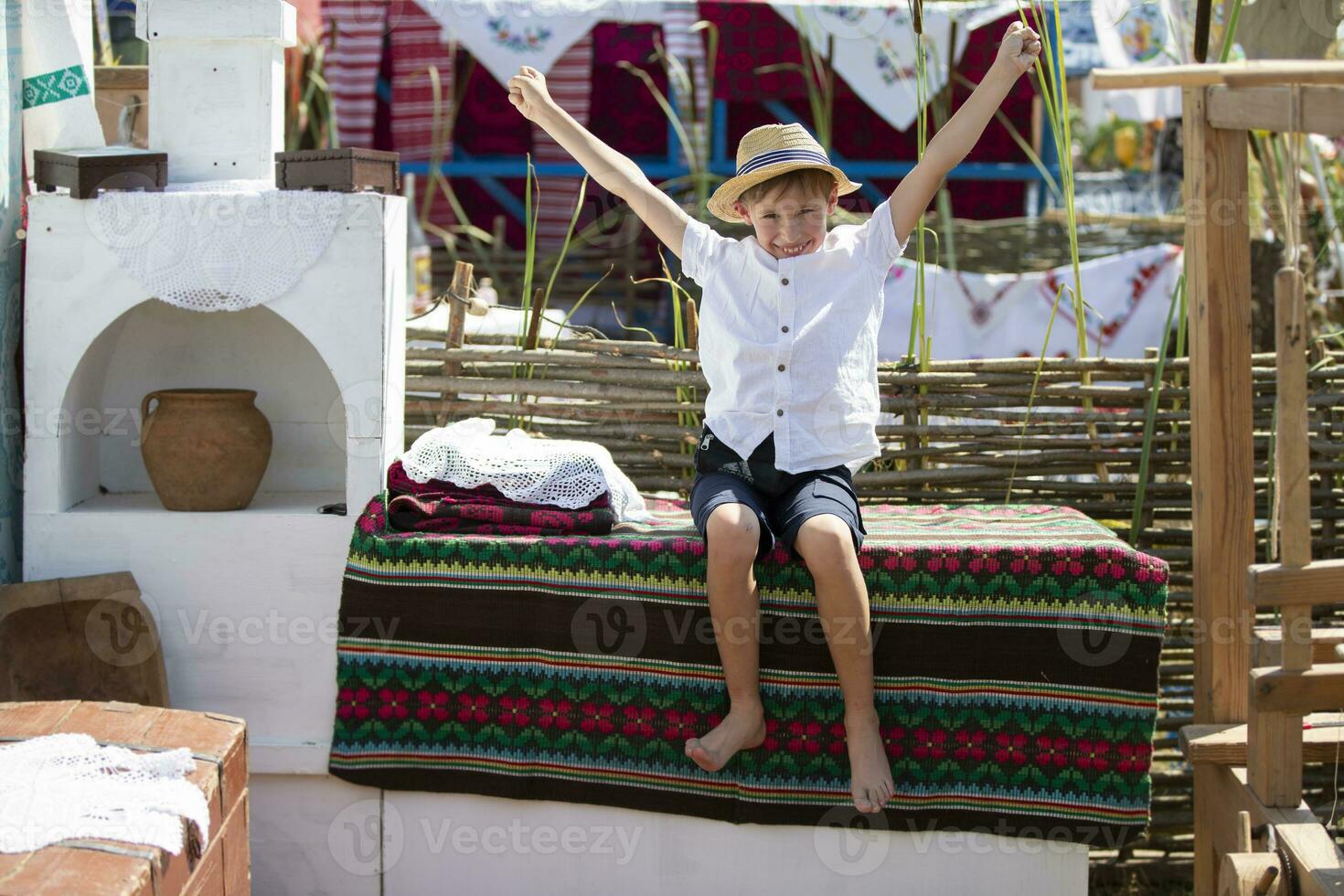 Belarusian or Ukrainian boy in an ethnic village. photo