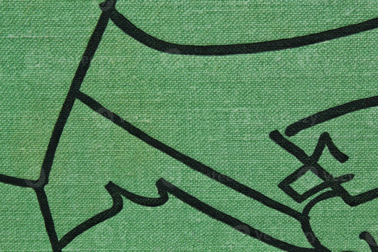 Abstract design background of green coarse-grained intersection texture of rough fabric with an interlacing black painted lines. Linen sack textile canvas burlap cloth. Close-up, mock up, top view photo