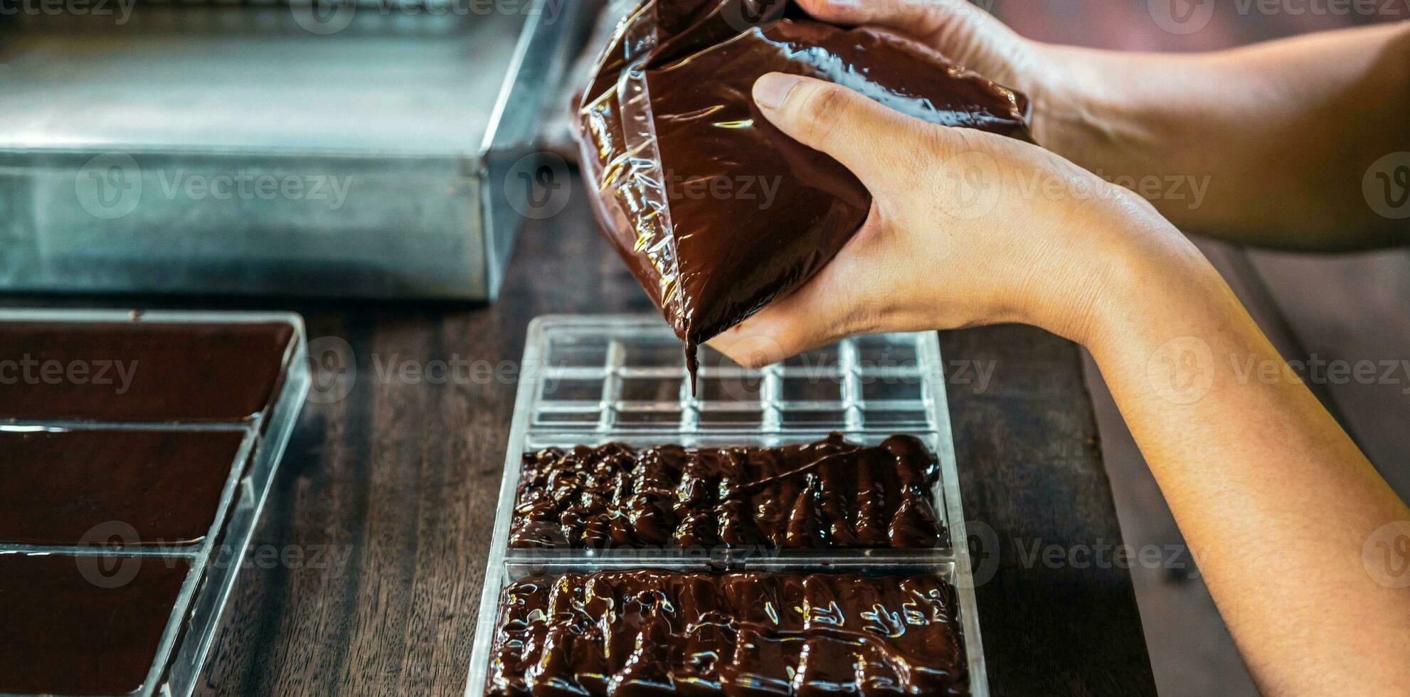 Close up of hand chef making homemade chocolate bars photo